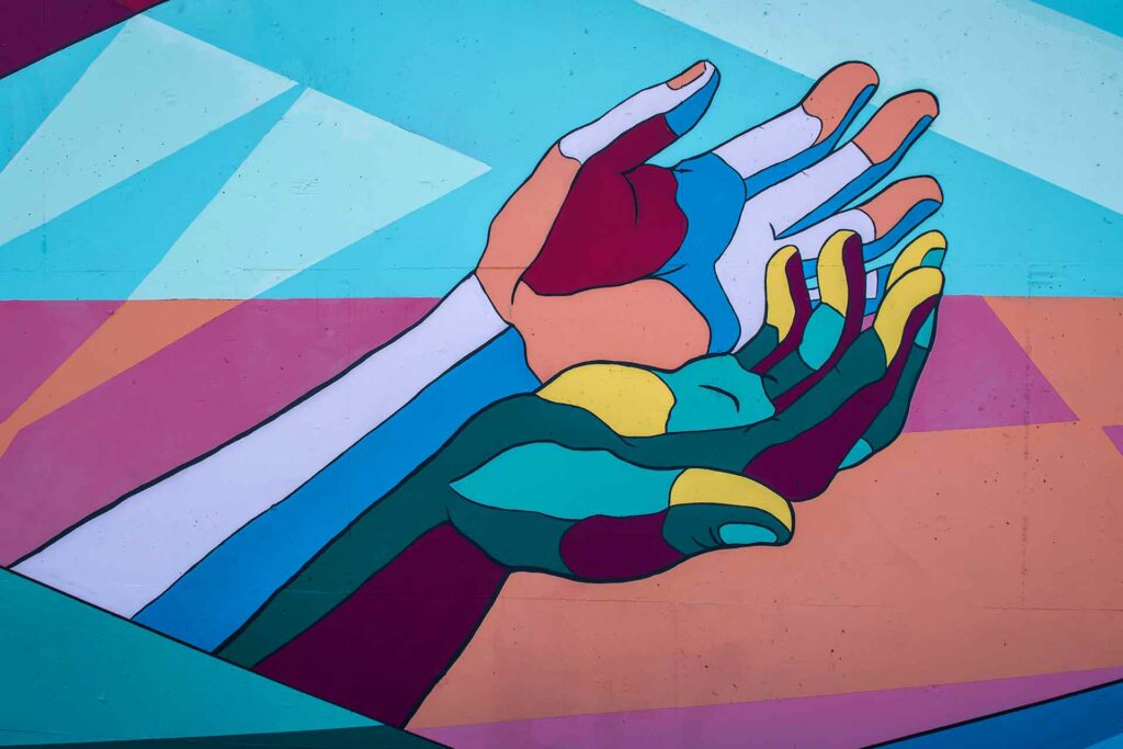 A coluorful painted hands on a wall